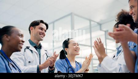 Ärzte, Krankenschwestern und Applaus im Krankenhaus für Gesundheit, medizinische Leistungen und Teamunterstützung. Menschen, Kardiologie und Klatschen in der Klinik Stockfoto