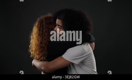 Junges, vielfältiges Paar, das sich eng umarmt, Liebe und emotionale Verbindung zeigt Stockfoto