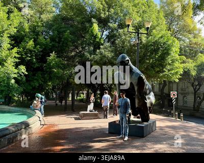 Menschen neben einer großen öffentlichen Skulptur neben dem Brunnen auf der Plaza Luis Cabrera, einem grünen Platz in Roma Norte, Mexiko-Stadt Stockfoto