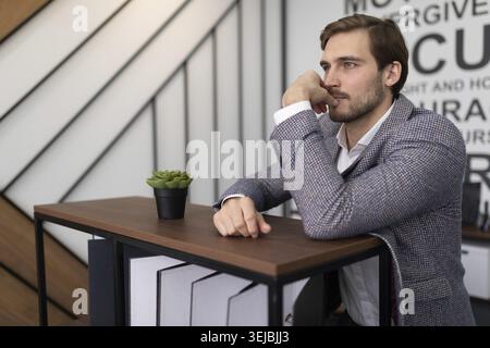 Porträt eines nachdenklichen Geschäftsmannes in einem stilvollen Büro Stockfoto