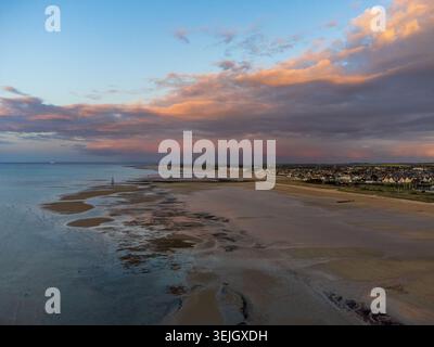 Spektakuläre Aussicht aus der Luft auf Courseulles-sur-Mer mit Ebbe, die Sandbänke und reflektierende Pools freigibt. Im Hintergrund, die Küstenstadt und eine Schönheit Stockfoto