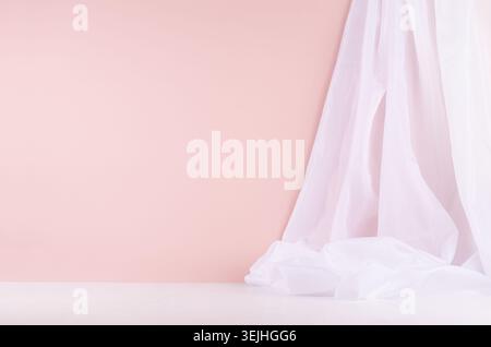 Minimalistisch elegante Inneneinrichtung der Galerie mit fliessenden Seidenvorhängen an rosa Wänden und weißem Holzboden, abstrakt zartem Hintergrund. Stockfoto