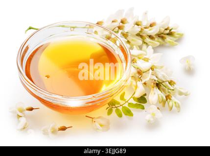 Natürlicher Bio-Honig in Glasschale, Honigpflanzen Akazienblüten und Blätter in der Nähe. Topv-Ansicht. Stockfoto