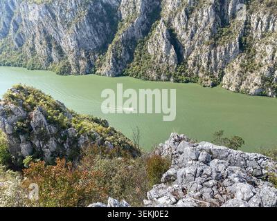 Motorboot auf der Donau unter den felsigen Klippen des Eisernen Tors Stockfoto