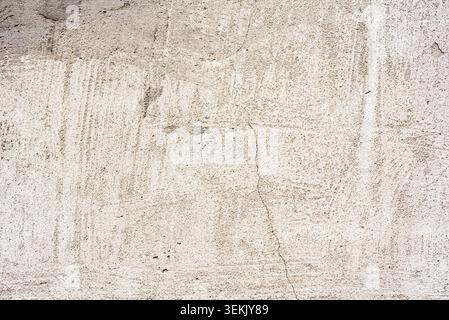 Textur, Wand, Beton, kann als Hintergrund verwendet werden. Wandfragment mit Kratzern und Rissen Stockfoto