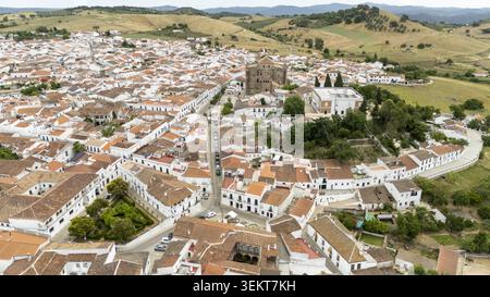 Blick aus der Vogelperspektive auf weiße Häuser mit Terrakotta-Dächern und die Parroquia de Nuestra Senora de la Consolacion in Cazalla de la Sierra, Andalusien, Spanien. Stockfoto