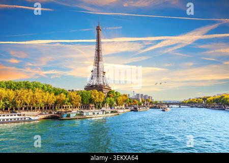 Atemberaubender Blick über die Drohne auf den beleuchteten Eiffelturm, Brücken und die seine in Paris bei einem goldenen romantischen Sonnenuntergang. Stockfoto