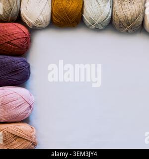 Buntes Garn auf grauem Hintergrund mit großem Kopierraum Stockfoto