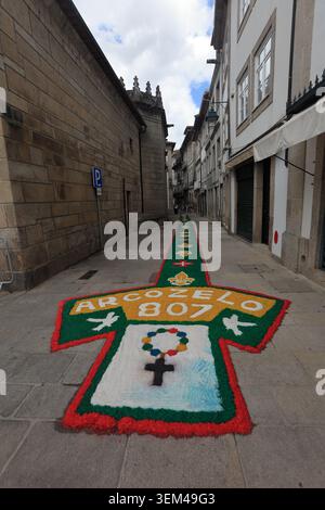 Ponte de Lima, Portugal - 4. Juni 2026: Besucher bewundern die komplizierten Sägemehl- und Blumenteppiche entlang der engen historischen Gassen von Ponte de Lima f Stockfoto