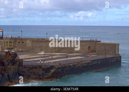 Puerto de la Cruz, Teneriffa - 9. November 2025 - Eine historische Steinmauer und Hafenpier mit Blick auf den Atlantik in Puerto de la Cruz, Tener Stockfoto
