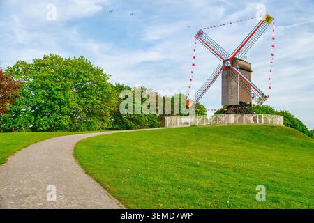 Historische Windmühlen säumen die alten Stadtmauern von Brügge während der goldenen Stunde und zeigen die traditionelle flämische Landschaft und den mittelalterlichen Charme Belgiens. I Stockfoto