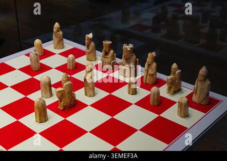 Lewis Chessmen, Walrosenelfenbein aus dem 12. Jahrhundert, auf nachgebildetem Schachbrett angeordnet, British Museum, Bloomsbury, London, Januar 2025. Stockfoto