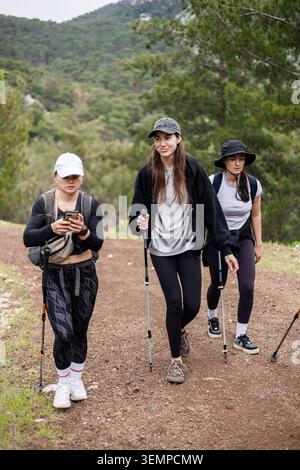 Drei Freundinnen wandern auf einem Bergweg Stockfoto