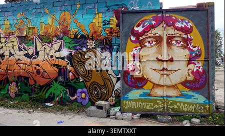 Stockholm, Schweden, 17. Mai 2026. Ein farbenfrohes Streetart-Porträt, gemalt auf Ziegel- und Metallpaneelen, umgeben von mehrschichtigen Graffiti und Blumenmotiv Stockfoto