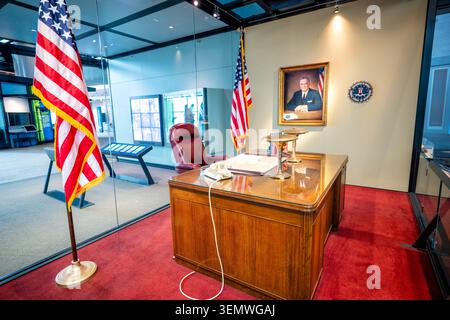 J Edgar Hoover Office Recreation National Law Enforcement Museum Washington DC / WASHINGTON D.C., Vereinigte Staaten — Eine Nachbildung von J. Edgar Hoovers Büro, verankert durch seinen originalen Schreibtisch und Ölporträt, steht hinter Glas im National Law Enforcement Museum am Judiciary Square. Hoover leitete das FBI von 1924 bis 1972 und saß fast fünf Jahrzehnte an diesem Schreibtisch, während er das Büro in eine mächtige Kriminalbekämpfungs- und Geheimdienstagentur verwandelte. Sein Vermächtnis bleibt für das COINTELPRO-Programm umstritten, das Bürgerrechtler und politische Dissidenten ins Visier nahm. Stockfoto