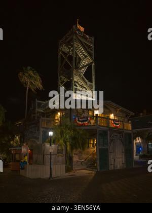 Key West, FL, USA - 13. Mai 2026: Das beleuchtete Gebäude des Key West Shipwreck Treasures Museum steht mit dem hohen Holzturm in der dunklen Nacht. Stockfoto