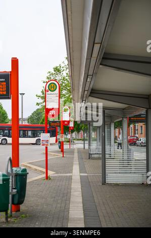 Iserlohn, Deutschland - 05. Juni 2026: Moderne städtische Bushaltestelleninfrastruktur mit elektronischem Display und ankommendem Bus. Stockfoto