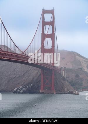 Der Golden Gate Bridge Tower erhebt sich an einem bewölkten Tag über der Bucht von San Francisco, Kalifornien, USA. Stockfoto