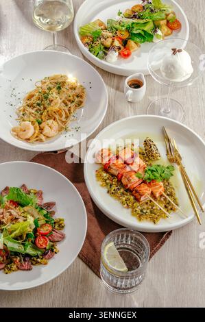 Auswahl an Gourmetgerichten auf einem Holztisch Stockfoto