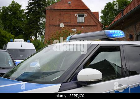 Teil eines deutschen Polizeiautos mit blinkender blauer Lichtleiste in einer Altstadt, ausgewählter Fokus Stockfoto