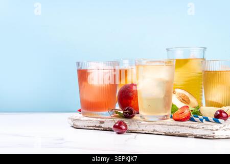 Sommer Erfrischungsgetränk, alkoholfreie Tee-basierte Cocktails, Eistee-Sorten in verschiedenen Gläsern, mit Fruchtsäften - Erdbeere, Pfirsich, Aprikose, che Stockfoto