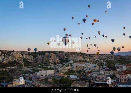 Ein spektakulärer Blick auf mehrere Heißluftballons, die während des Sonnenaufgangs über Kappadokien schweben. Stockfoto