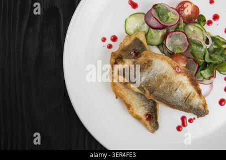 Filet von zander mit Gemüse auf einem Teller in einem Restaurant Stockfoto