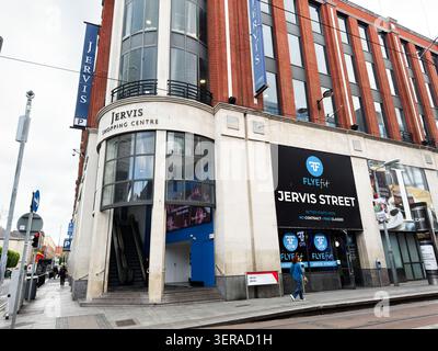 Dublin, Irland - 22. Mai 2026: Urbane Straßenszene mit Eingang zum Jervis Shopping Centre, Flyefit-Beschilderung zum Fitnessstudio und einem Fußgänger auf der Jervis Street, Dub Stockfoto
