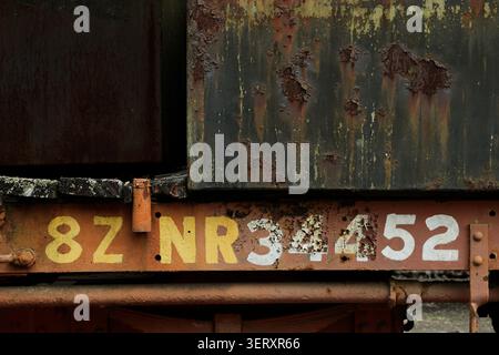 Verblasste Nummer auf altem Eisenbahnwaggon, verrostetes Metall an vergessenen Menschengebilden, Farbe blättert mit dem Alter ab, Einwirkung der Naturllemente über die Zeit Stockfoto