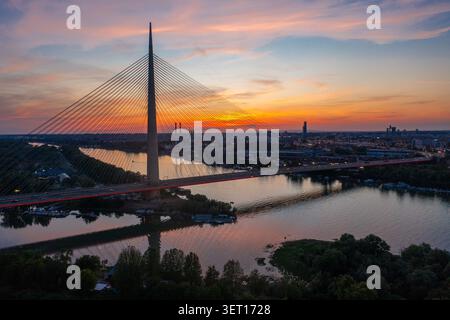 Luftaufnahme der Ada-Brücke über die Save in Belgrad, Serbien, bei Sonnenuntergang. Die Kabelbrücke ist eine der wichtigsten Bauwerke der Stadt Stockfoto