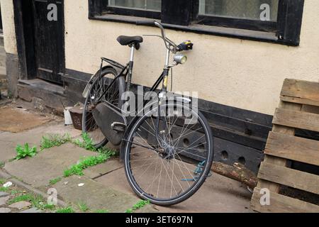 Altenmodisches Fahrrad lehnt an einer Wand. Stockfoto