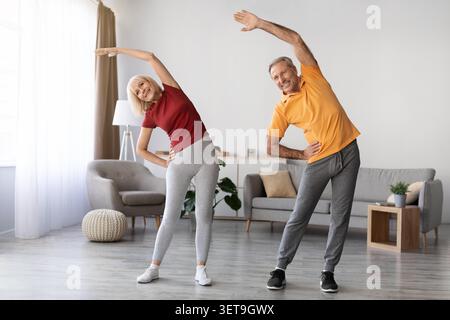 Aktives Älteres Kaukasisches Paar, Das Sich Zu Hause Ausdehnt, Wellness-Konzept Stockfoto