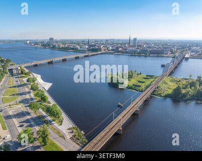 Panoramablick auf Riga Altstadt, Daugava Fluss, Eisenbahnbrücke und Steinbrücke an einem sonnigen Sommermorgen, Lettland Stockfoto