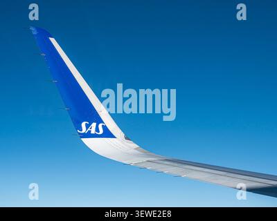 Eine Nahaufnahme eines modernen kommerziellen Flugzeuges Flügelspitze, der in großer Höhe vor einem völlig klaren, leuchtend blauen Himmel segelt Stockfoto