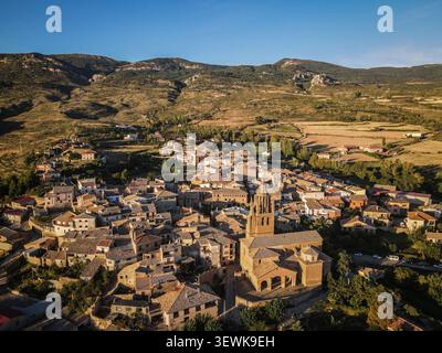 Ein Weitwinkelfoto aus der Luft fängt das Dorf Uncastillo ein, mit der Kirche Santa María, eingebettet in die aragonesischen Berge in Saragoza, Spa Stockfoto