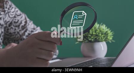 Durch das Objektiv wird ein leuchtendes digitales Symbol eines persönlichen Profildokuments oder Lebenslaufs sichtbar. Stockfoto