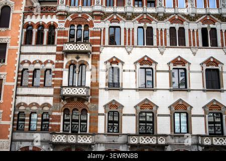 Detaillierter Blick auf die hochdekorative Fassade eines historischen Gebäudes an der Via XX Settembre mit neogotischen Doppelfenstern, roten Backsteinmustern, Stockfoto