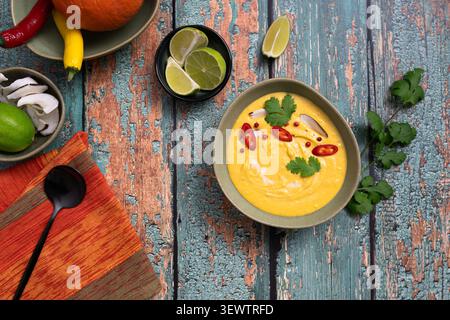 Thailändische Suppe von oben, garniert mit Chili-Limette und frischen Korianderblättern Stockfoto
