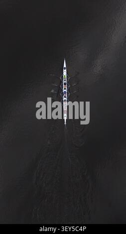 Luftdrohne von oben nach unten auf das Ruderteam-Training auf dem Fluss Stockfoto