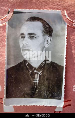 Vintage-Schwarz-weiß-Porträt Eines ernsten Mannes aus der Mitte des Jahrhunderts in einem Fotoalbum der alten Familie. Profil Stockfoto