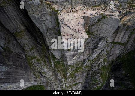 Blick aus der Vogelperspektive auf den Kanzel Rock mit einer großen Gruppe von Wanderern auf dem flachen Klippenplateau mit Blick auf das tiefe Lysefjord-Tal in Strand, Rogal Stockfoto