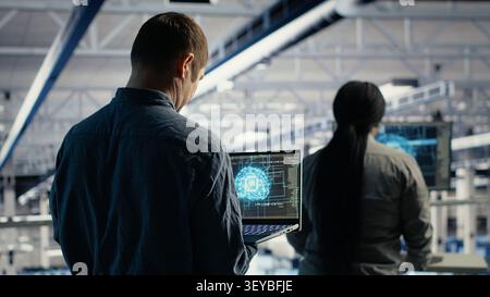 Der Administrator des Rechenzentrums verwendet einen Laptop, um Deep Learning-Prozesse zu überwachen und mit KI-Technologie und Hochleistungssystemen zu arbeiten. Stockfoto