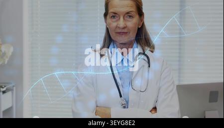 Seniorärztin senkt die Arme und lächelt in der Klinik, animierte DNA-Helix löst Entspannung aus Stockfoto