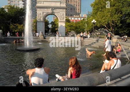 New York, Usa. Juli 2026. Menschen sitzen um einen Brunnen im Washington Square Park, Manhattan, New York City. Quelle: SOPA Images Limited/Alamy Live News Stockfoto