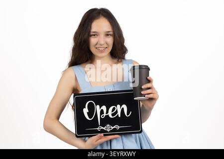 Junge Frau, die ein offenes Schild für den Einzelhandel hält Stockfoto