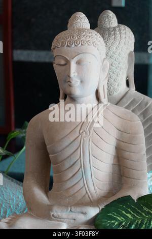 Weiße Sandstein-Buddha-Statue in Meditationspose für die Inneneinrichtung Stockfoto