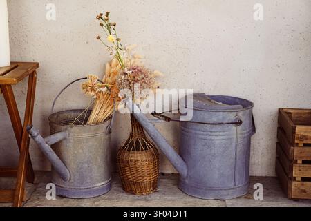 Nahaufnahme eines rustikalen Stilllebens mit Messinggießkannen. Stockfoto