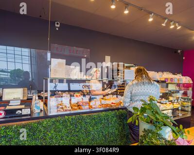 Washington State, USA, 20. Juni 2026 - Ein Kunde steht am Schalter der Fuji Bakery im Bundesstaat Washington, während ein Mitarbeiter Gebäck serviert Stockfoto