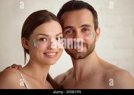 Reifes Ehepaar, das bei der Schönheitsbehandlung zu Hause unter Augenflecken trägt. Stockfoto