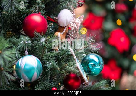 Bunte Weihnachtsschmuck und Kugeln hängen am Baum. Konzept der Feiertagssaison. Stockfoto